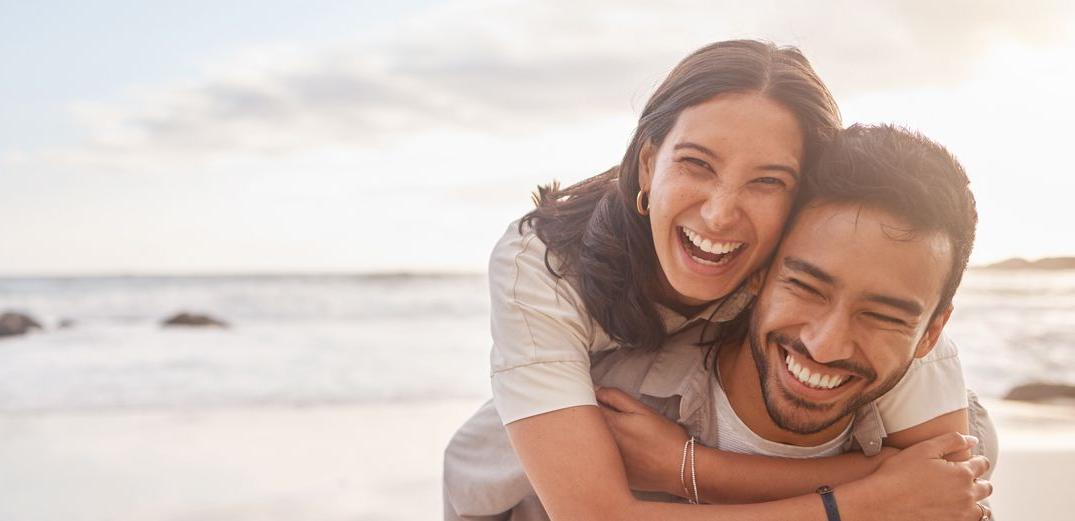 A young couple has fun at the beach.